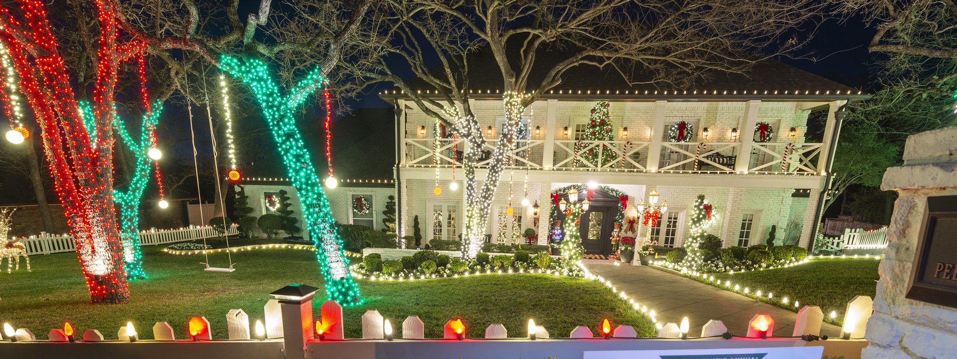 Award-winning full home holiday lighting display with lit trees, roofline lights and decorations